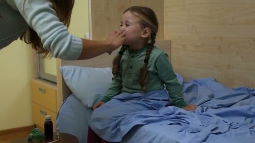 Girl Receives Nasal Ointment While Sitting on Bed