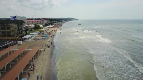 Aerial view of the luxury resort. Beach with tourists, sun loungers and umbrellas