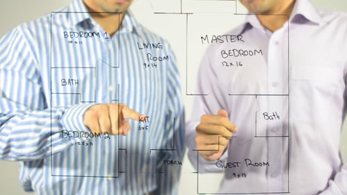Businessmen Discussing Blueprint
