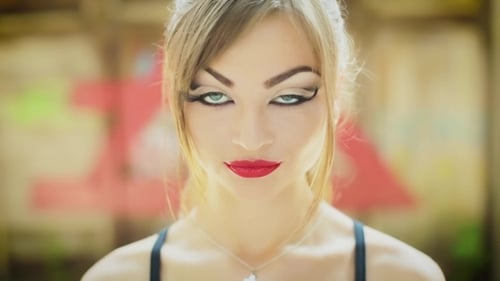 Close-Up of Smiling Young Woman in Urban Setting