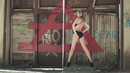 Woman Dances in Lingerie Before Graffiti Doors