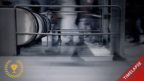 Anonymous People Walking Past Railing and Escalator