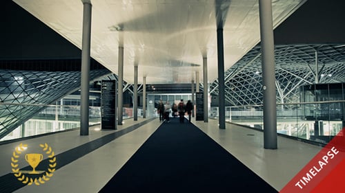 People Walking Through a Modern Building at Night