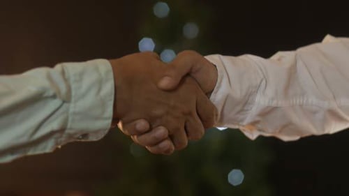Handshake with Lights at Night