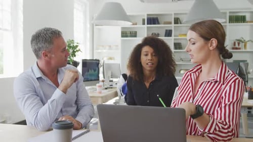 Office Colleagues Discussing Project at Laptop