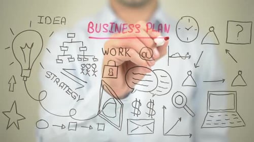 Hand Writing Business Plan on Transparent Surface
