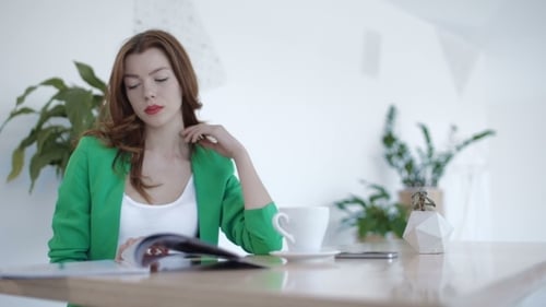 Stylish Woman Reading Magazine and Drinking Coffee