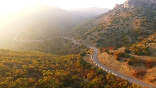 Flying Above Autumn Forest With Mountain Road