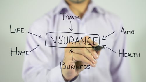 Man Writes Insurance Plan on Clear Surface