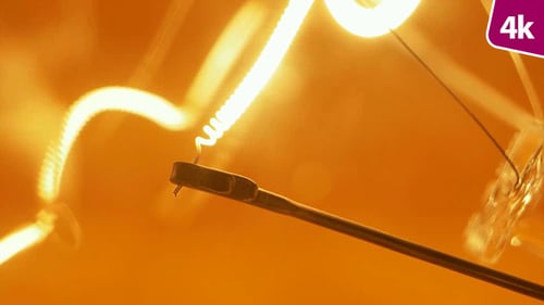 Extreme Close Up of Glowing Light Bulb Filament