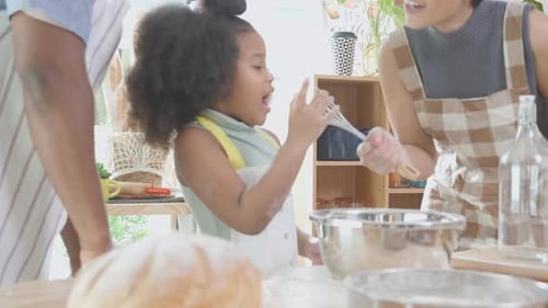 African America family wearing apron thresh flour for cooking and dancing and song together.