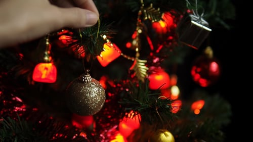 Decorating Christmas Tree With Golden Bauble
