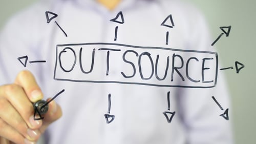 Man Writes Outsource, Draws Diagram on Clear Surface