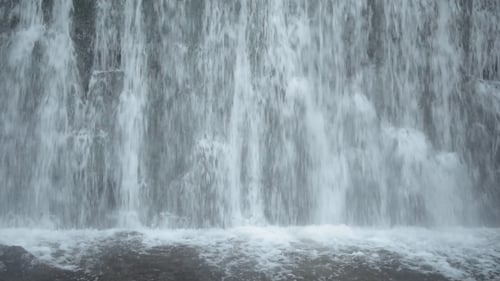Cascading Water Flows Down Waterfall in Natural Setting
