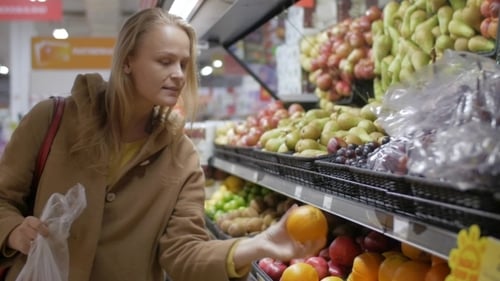 Woman Shopping for Fruit in Grocery Store