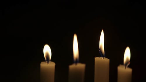 Four Candles Glowing in the Darkness