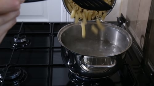 Cooking Pasta in Boiling Water on Stove