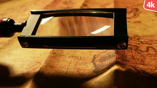 Magnifying Glass on Antique Map for Exploration
