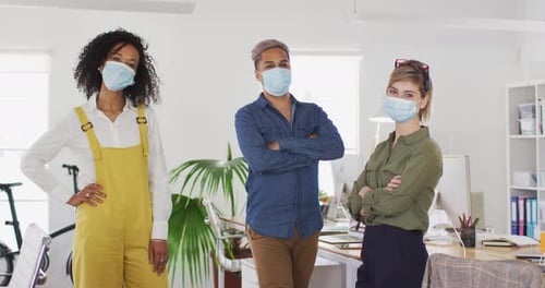 Office colleagues wearing face masks standing in office