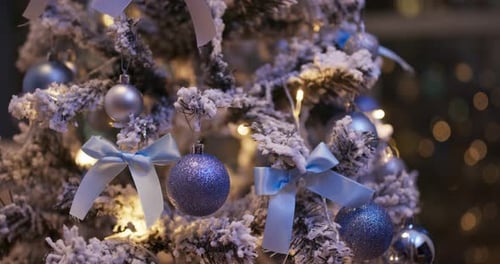 Christmas Tree Decorated with Blue Ornaments and Ribbons