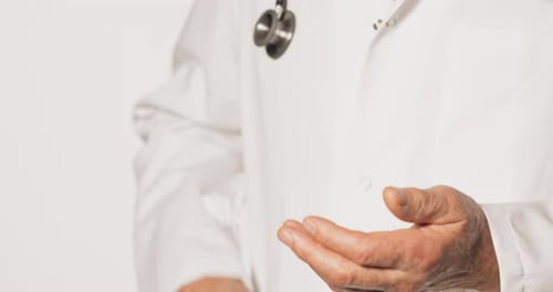 Mature Adult Using Hand Sanitizer in Hospital