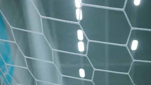 Blurred View of Gym Ceiling with Led Lamps Through Gate Mesh