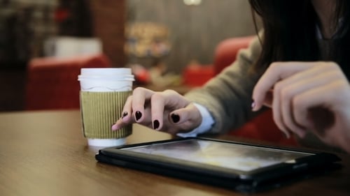 Woman Hands Using Tablet Touchscreen In Cafe