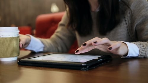 Woman Hands Using Tablet Touchscreen In Cafe