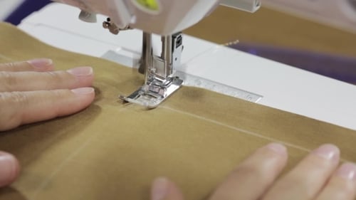 Female Hands Sewing Fabric On Sewing Machine