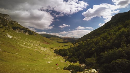 Scenic Mountain Valley With Green Hills and Forests