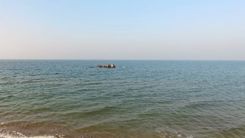 Flying Above Sea With Rocky And Sand Coast