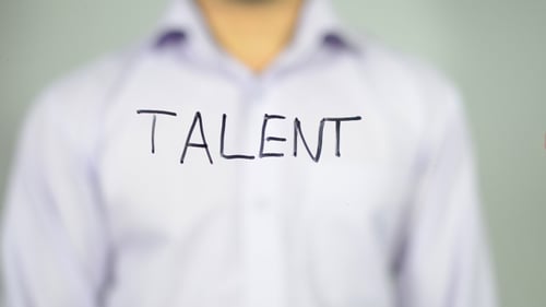 Man Writes the Word Talent on Glass