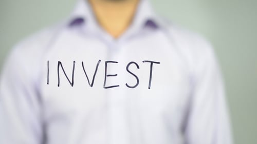 Hand Writing Word Invest with Black Marker