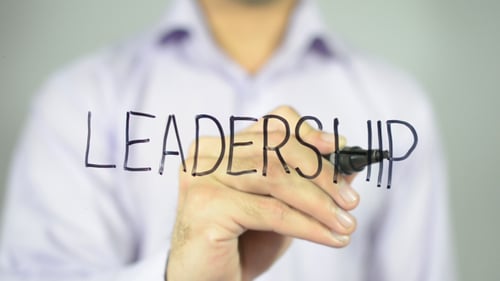 Hand Writing Leadership on Clear Surface Close Up