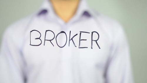 Man Writes Broker on Transparent Surface