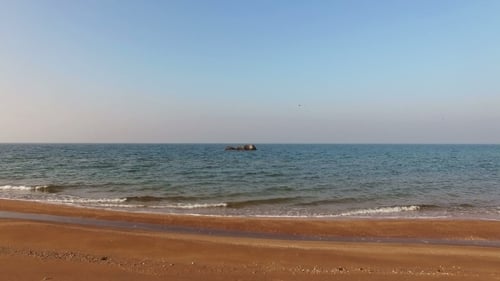 Flying Above Sea With Rocky And Sand Coast