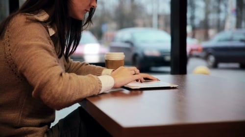 Woman Hands Using Tablet Touchscreen In Cafe