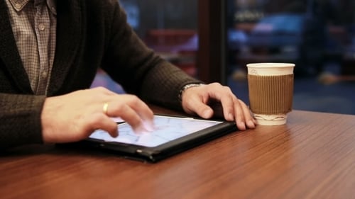 Man Hands Using Tablet Touchscreen In Cafe