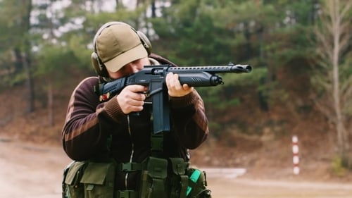 Man Shooting a Shotgun