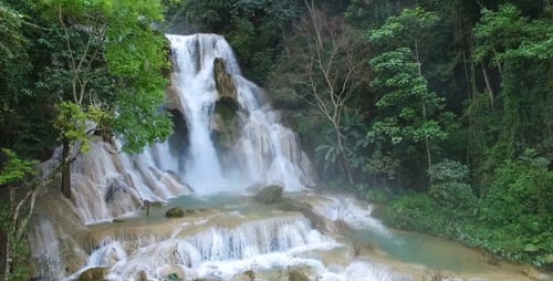 Tropical Waterfall Cascades Through Lush Green Forest
