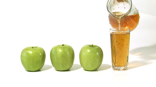 Fresh Apple Juice Poured Into Glass With Straw