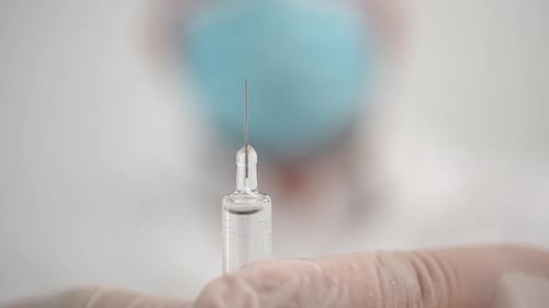 Close Up of Ampule with Needle and Liquid