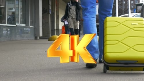 Man With A Suitcase On Wheels In The City Street