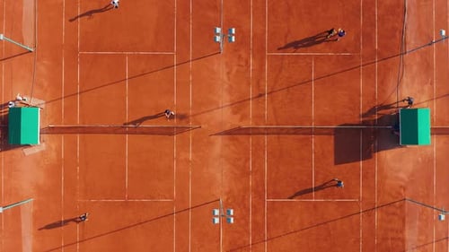 Tennis Players in Action During Game on the Professional Stadium