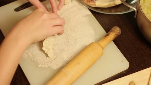 Rolling Dough on Cutting Board with Rolling Pin