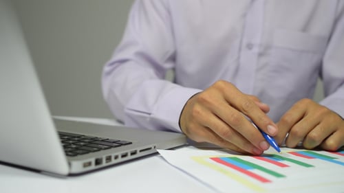 Working on Data with Computer at Desk