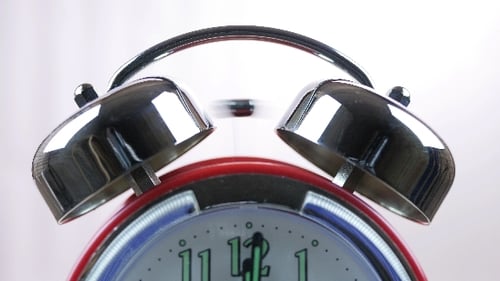 Red Alarm Clock Ringing Loudly Close Up