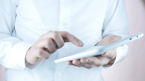 Tablet Operation by a Person in White Shirt