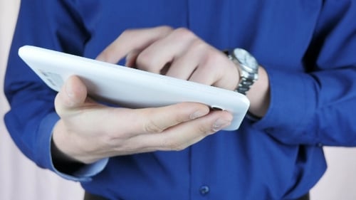 Man Scrolling on Touchscreen Tablet Device