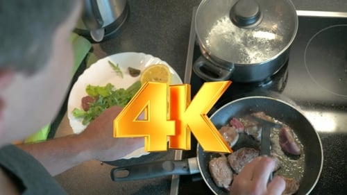 Person Cooking Meat in Frying Pan